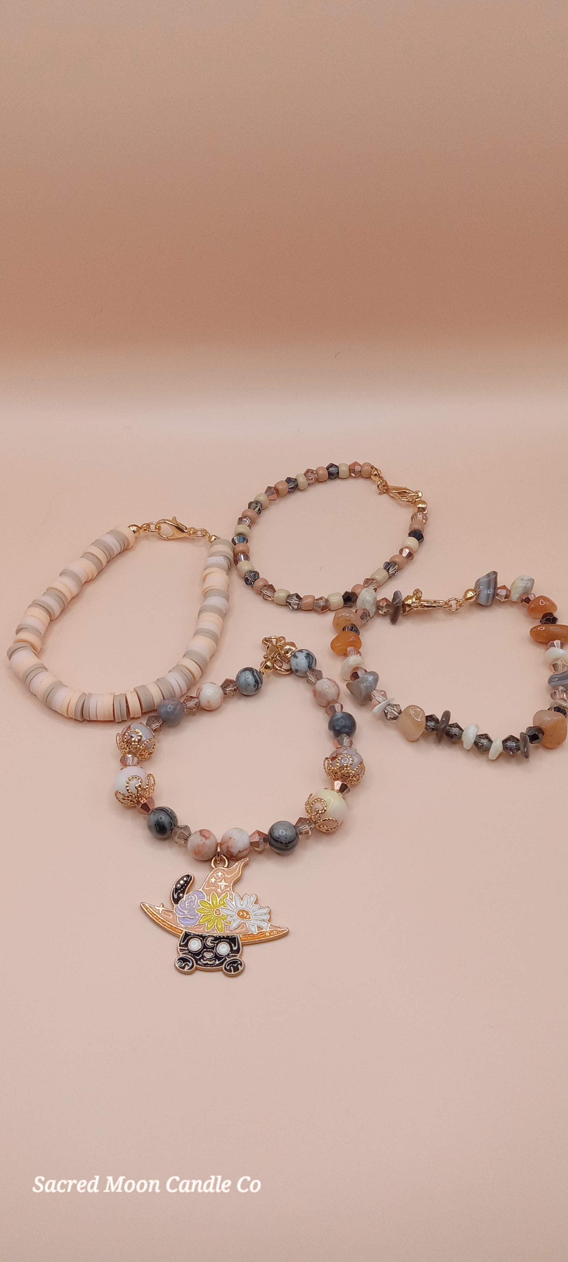 Sacred Moon Candle Co witchy cat charm bracelet stack with beads in neutral and earthy tones