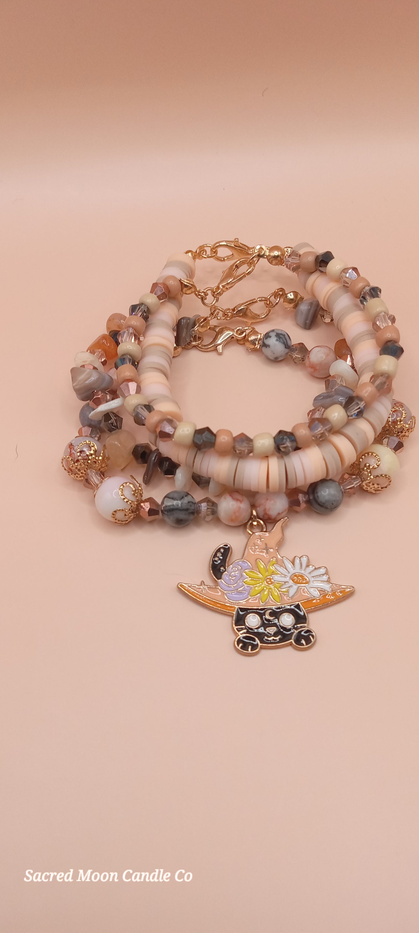 Sacred Moon Candle Co bracelet stack featuring a witchy cat charm bracelet with natural stone beads