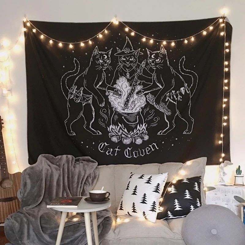 Witchy cat tapestry featuring three black cats casting spells around a cauldron hanging on wall