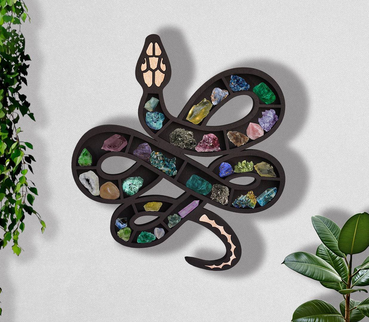 Wooden snake or cat shelf for crystals by Sacred Moon Candle Co displaying colorful crystals on wall decor