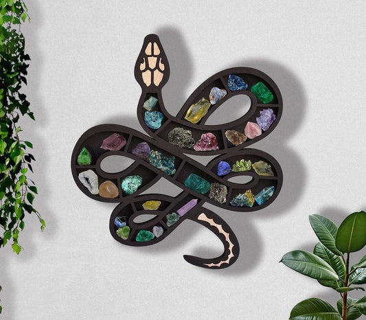 Wooden snake or cat shelf for crystals by Sacred Moon Candle Co displaying colorful crystals on wall decor