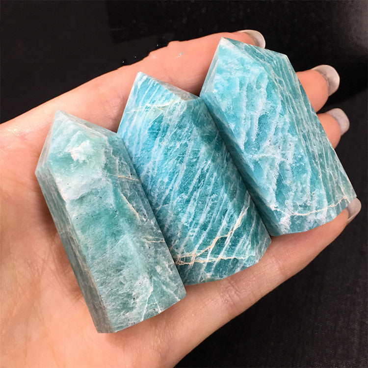 Sacred Moon Candle Co hand holding natural tianhe stone crystal column trio polished blue green healing towers